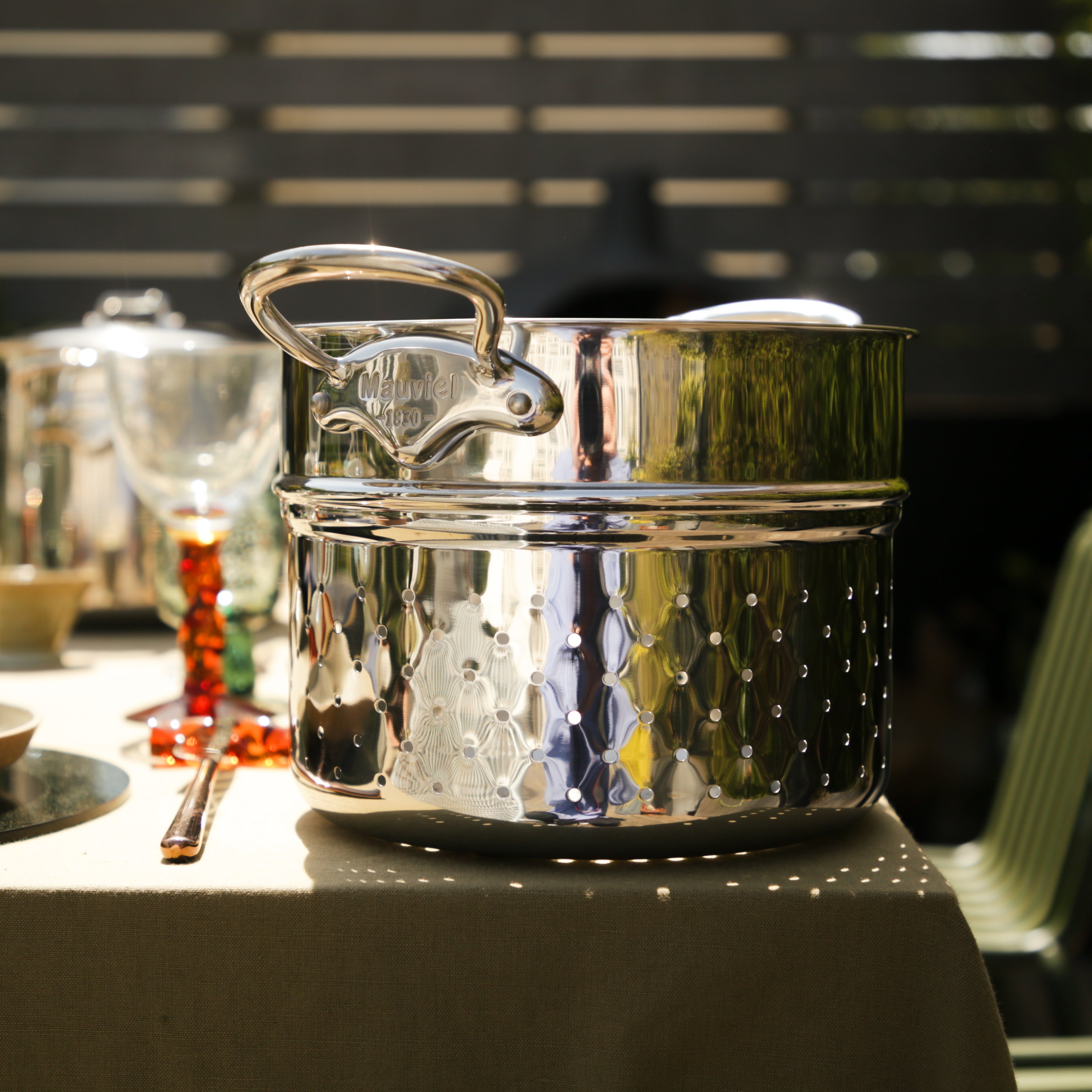 Mauviel 9.4-inch stainless steel pasta insert with cast handle, perfect for draining and serving pasta in cookware.