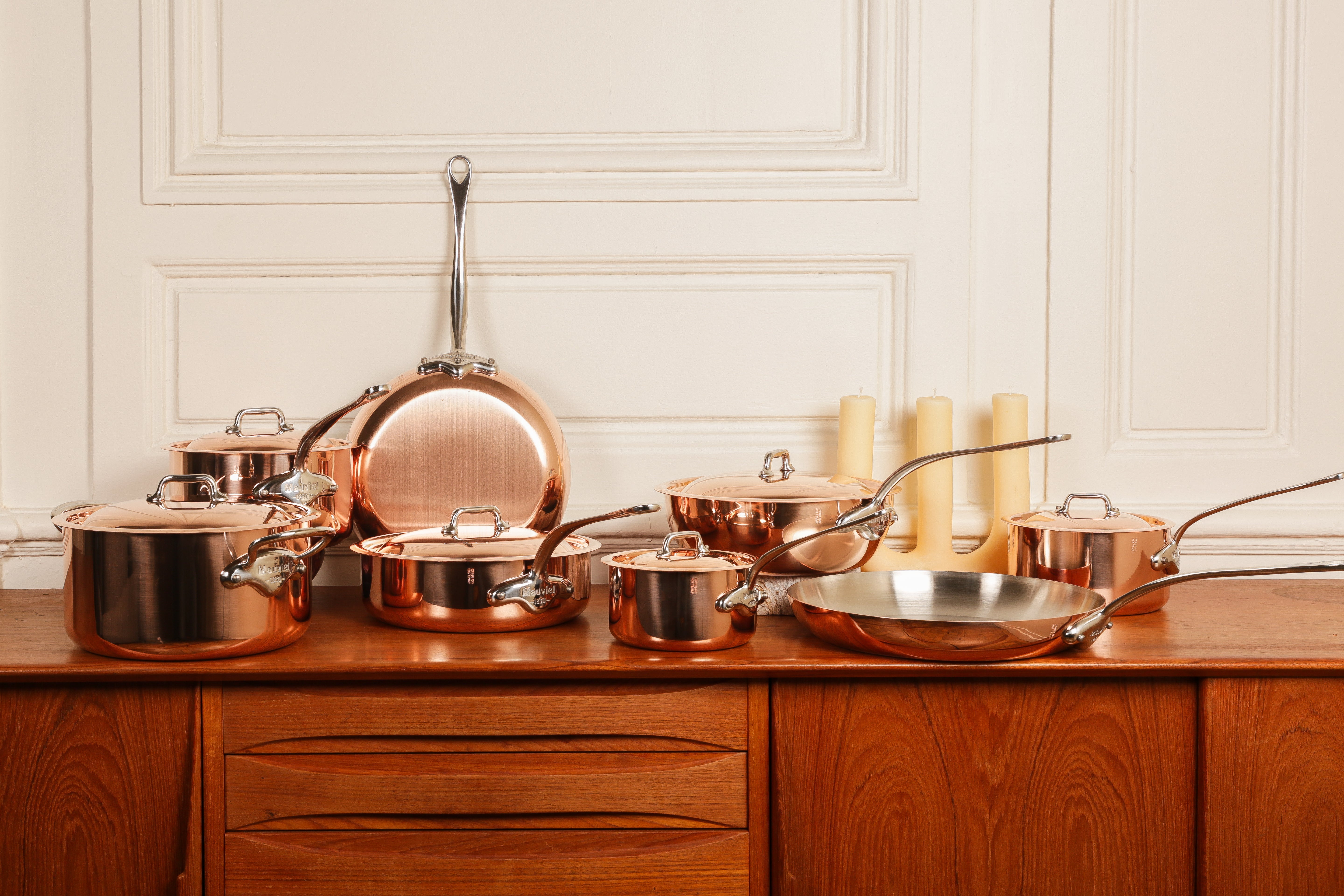 Mauviel copper cookware set including saucepans, sauté pan, and stockpot with bronze handles