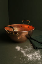 Mauviel M'PASSION copper syrup pan with brass handles, specialty cookware for precise syrup making, on a kitchen countertop.
