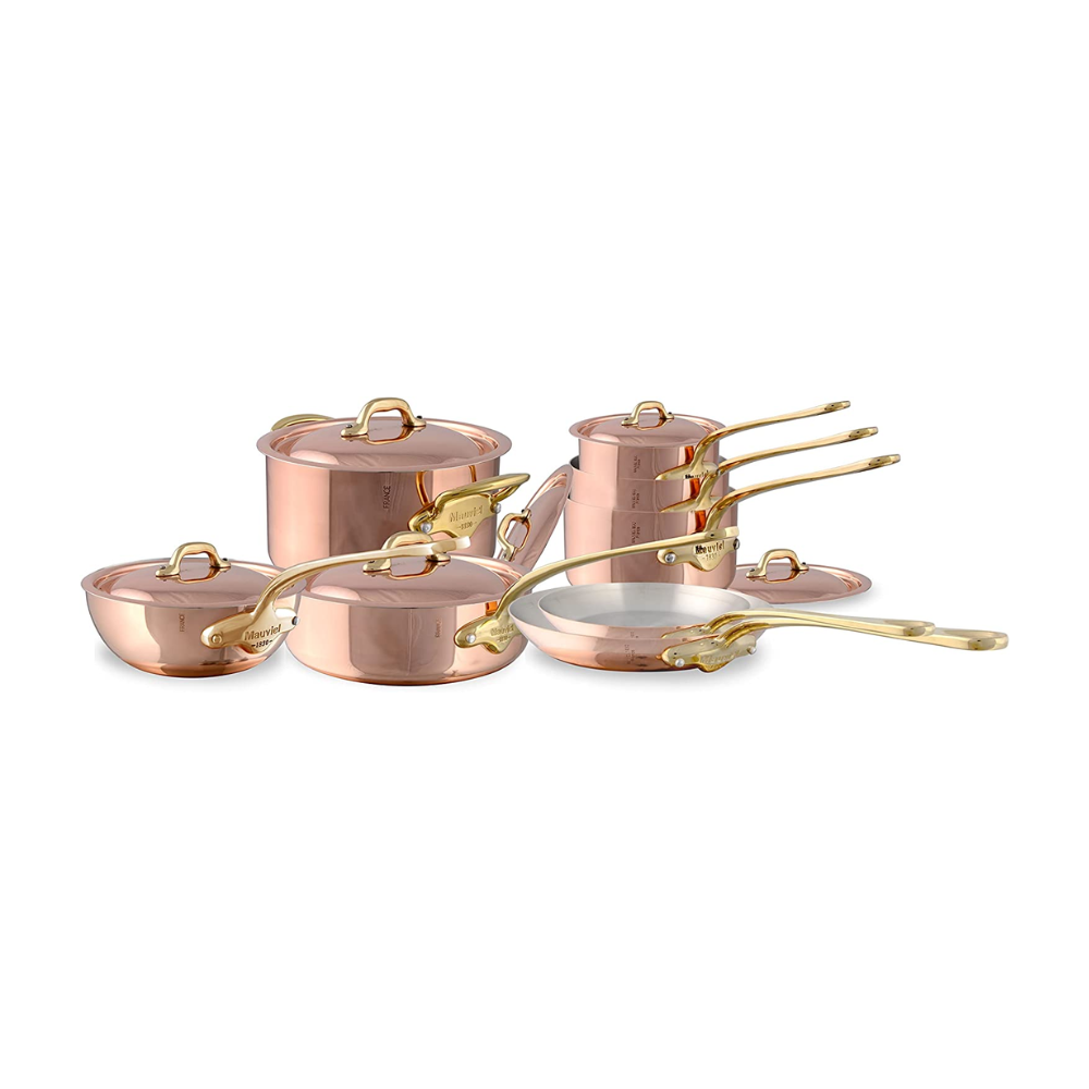 Mauviel M'Heritage M'150 B 14-piece copper cookware set with brass handles, including various pots and pans on a stovetop.