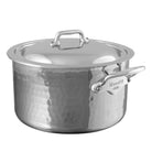 Mauviel M'ELITE hammered stainless steel stewpan with curved lid and cast stainless steel handles on a kitchen stovetop.