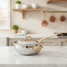 Mauviel M'COOK 5-ply chef pan with brass handle and lid for professional cooking and even heat distribution.
