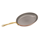 Mauviel M'Heritage M'150 B copper oval frying pan with brass handle, showcasing its polished copper surface and sturdy brass grip.