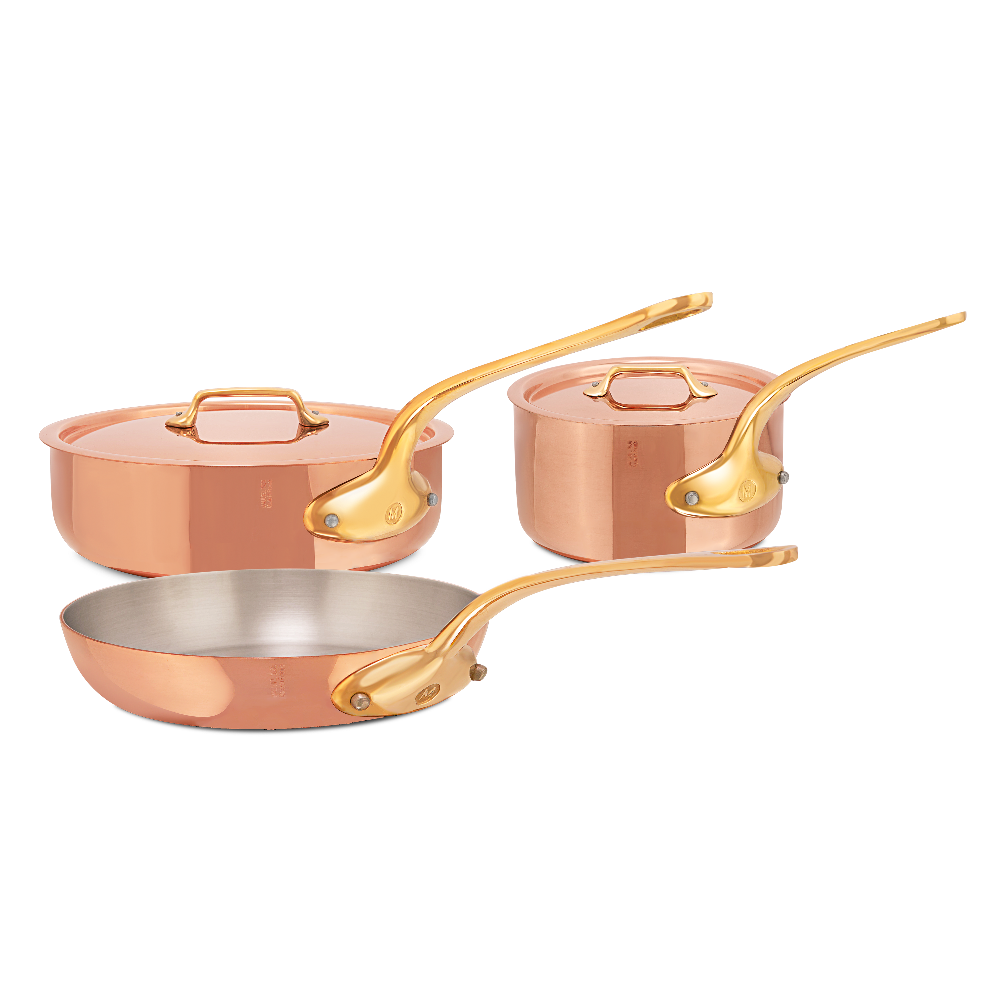 Mauviel M'Heritage M'200 B 5-piece copper cookware set with brass handles, including saucepans and frying pans on a kitchen countertop.
