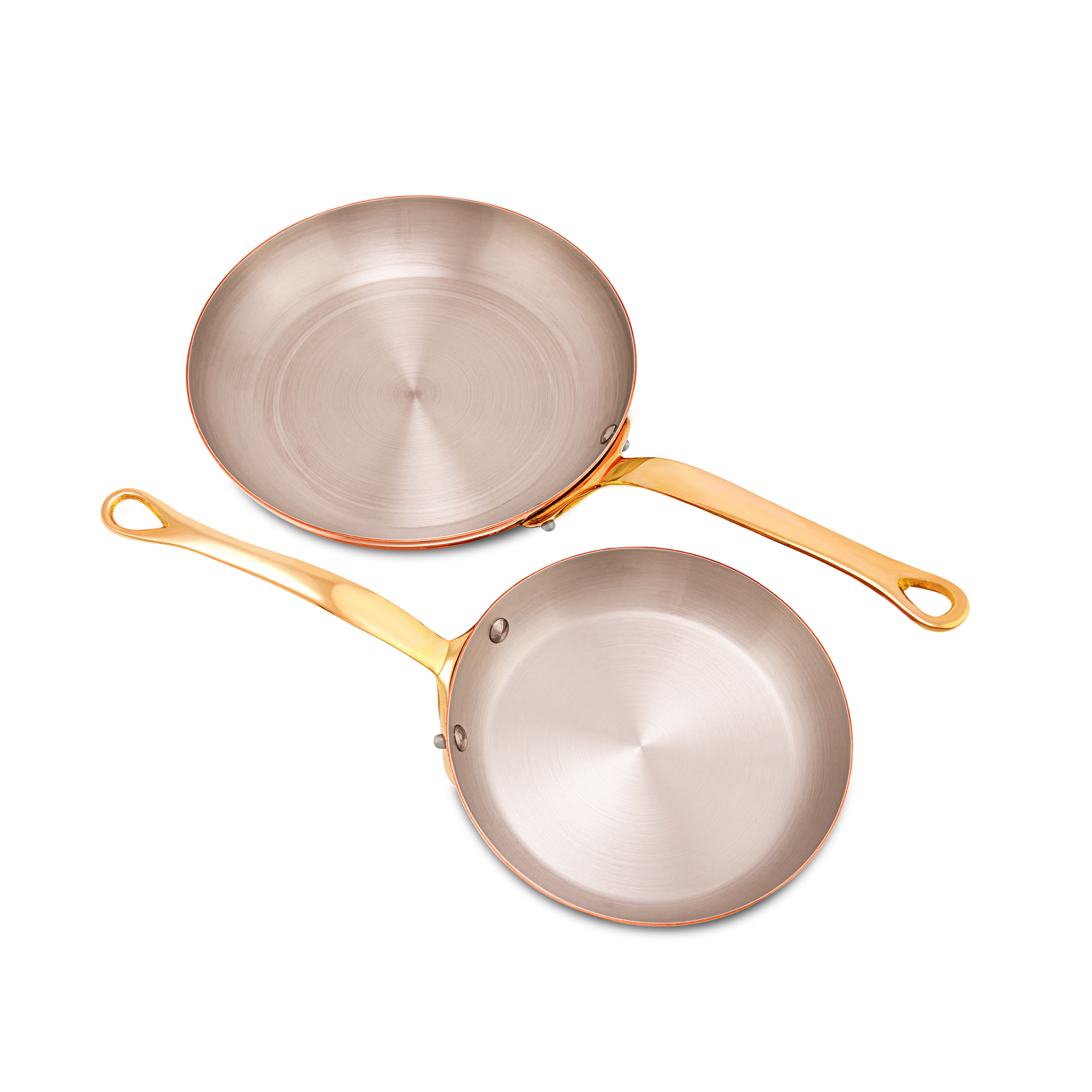 Mauviel M'Heritage M'200 B 2-piece cookware set with brass handles, including frying pans, on a kitchen countertop.