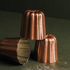 Mauviel M'PASSION copper canelé mold set with four tinned copper molds for baking traditional canelés.