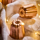 Mauviel M'PASSION copper canele mold set with four tinned copper molds for baking traditional caneles.