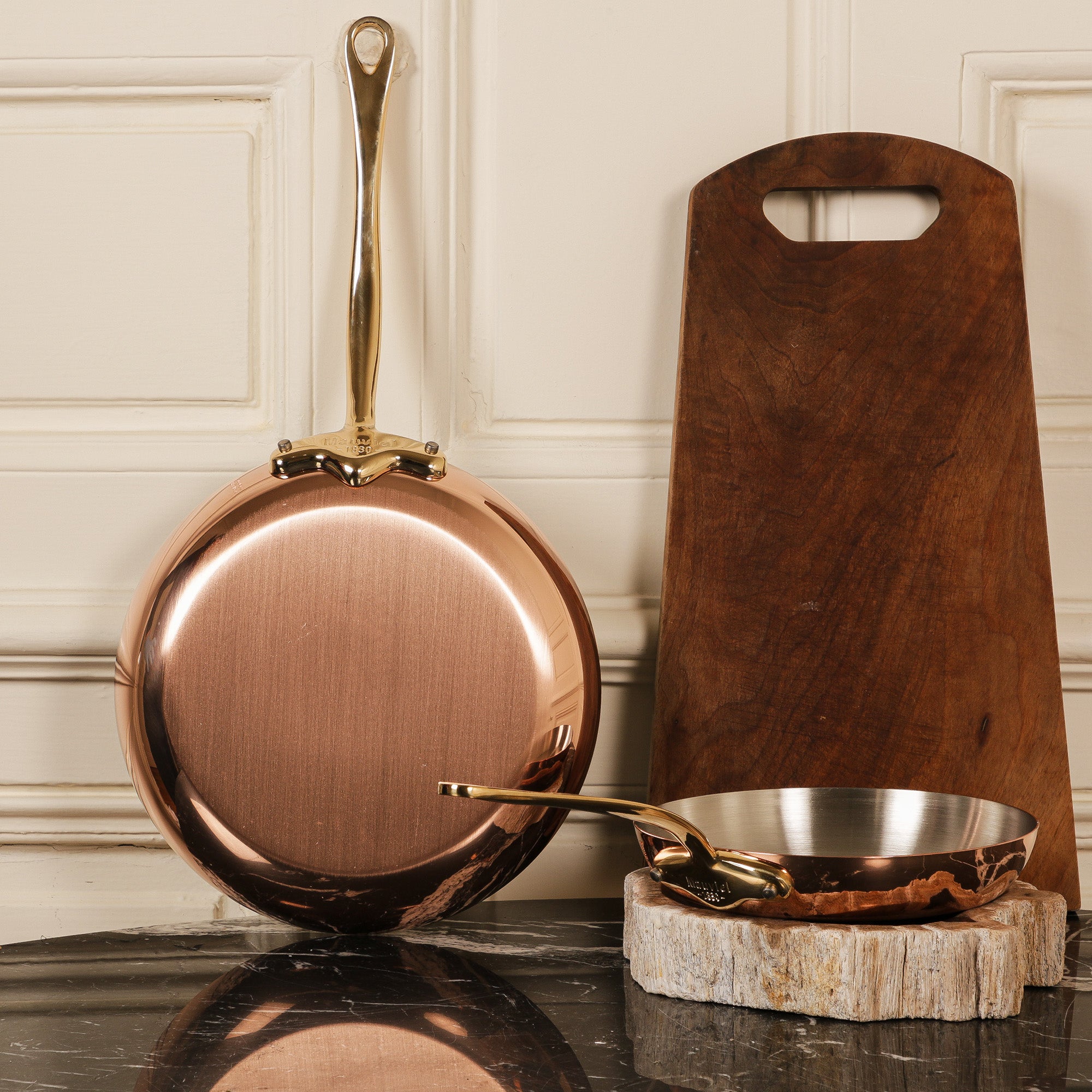 Mauviel M'Heritage M'150 B copper oval frying pan set with brass handles, showing two pans with polished copper surfaces.