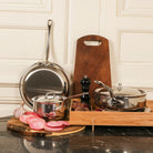 Mauviel M'COOK 5-ply 2-piece frying pan set with stainless steel handles, showcasing shiny, durable cookware on a kitchen surface.