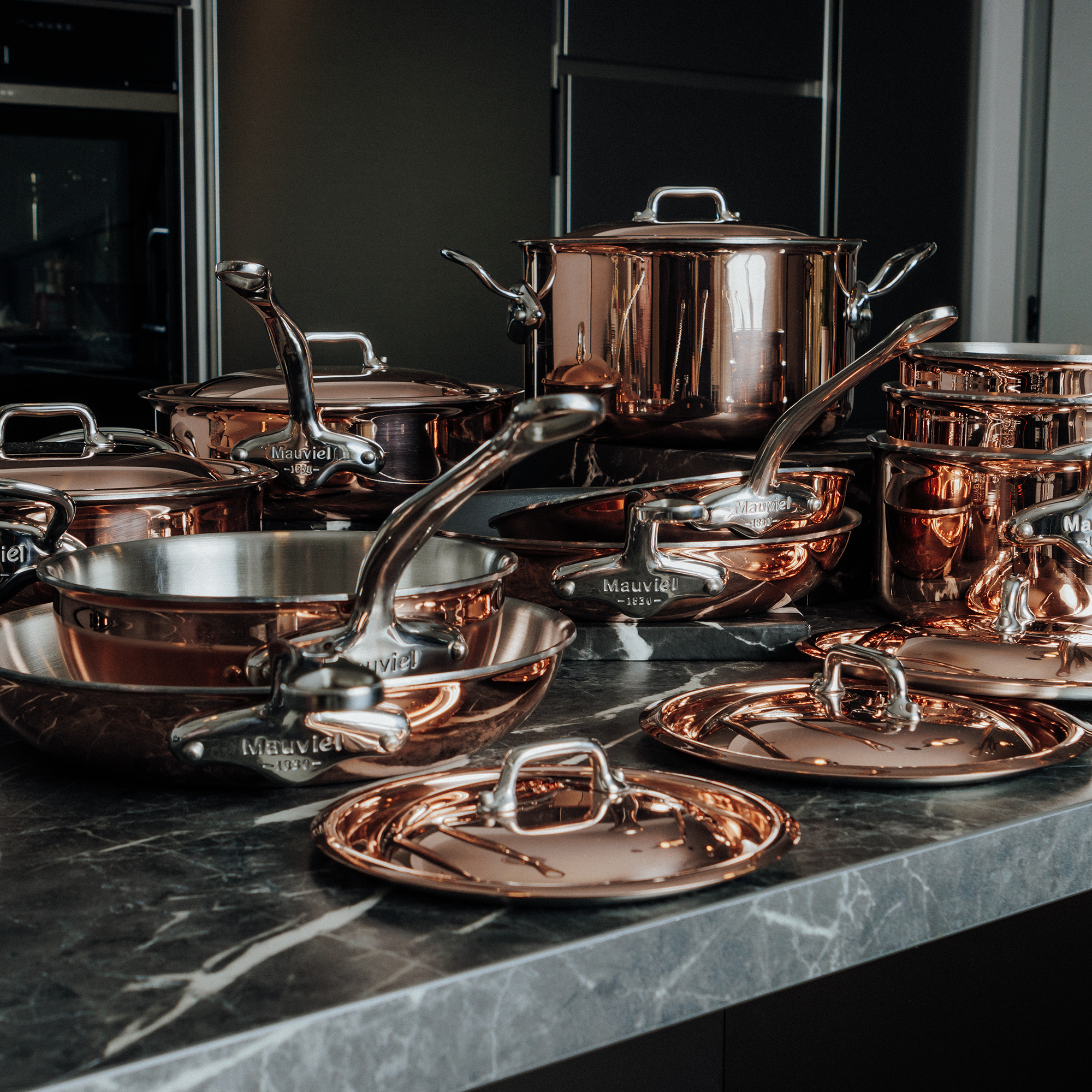 Mauviel M'6 S induction copper saute pan with lid, curved sides, cast stainless steel handle, 2.1-quart chef pan on stovetop