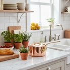 Mauviel M'Heritage M'250 B copper sauce pan with brass handle and lid, showcasing its polished copper surface and sturdy design.