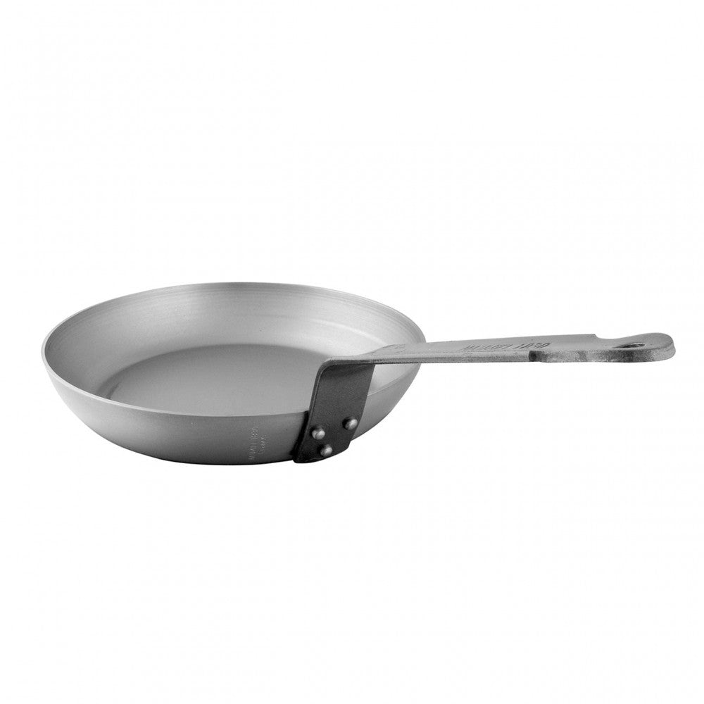 Mauviel M'STEEL black carbon steel round frying pan with iron handle, showing the smooth cooking surface and sturdy handle.