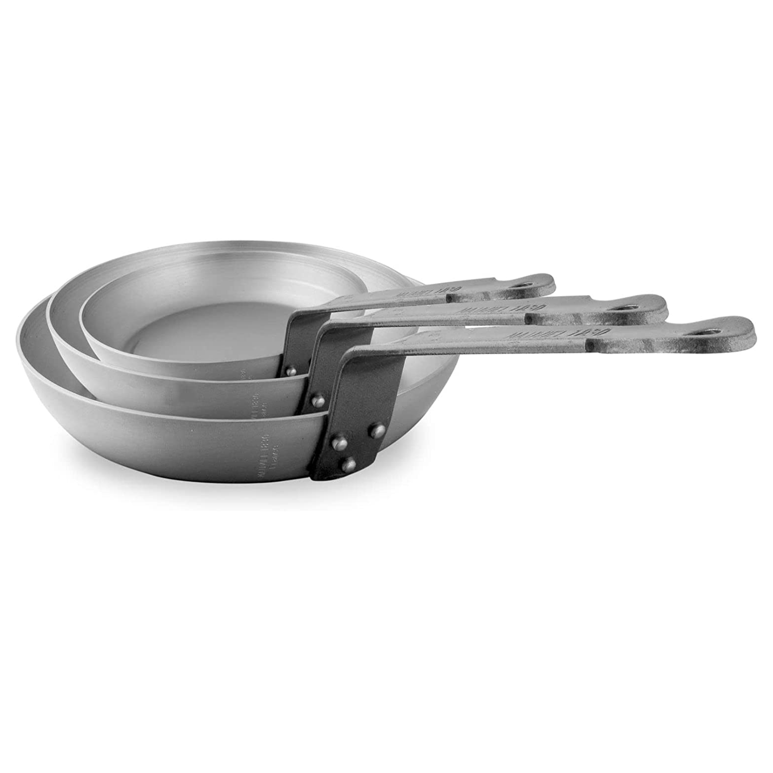 Mauviel M'STEEL black carbon nonstick 3-piece frying pan set with iron handles, shown stacked on a kitchen countertop.